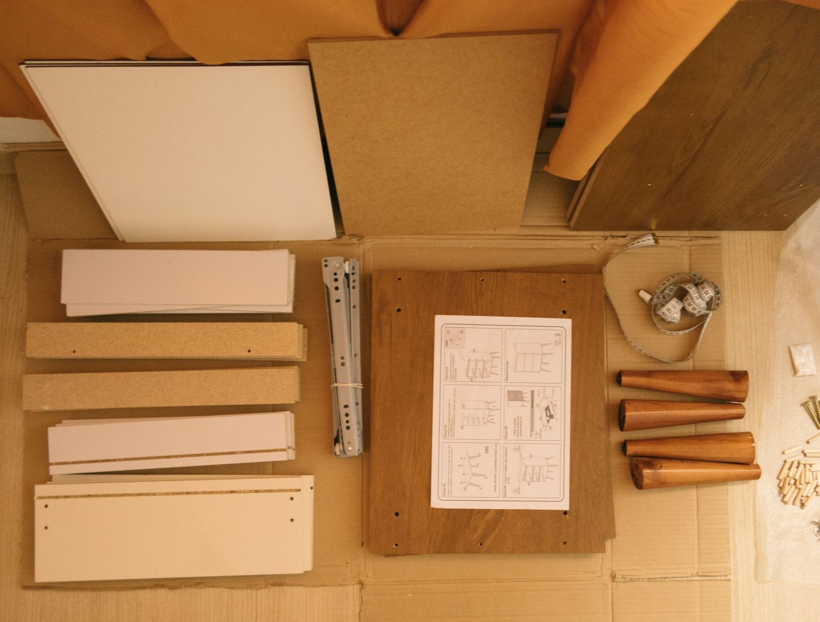 Sortierte Bauteile und Anleitung auf dem Karton vor der Montage